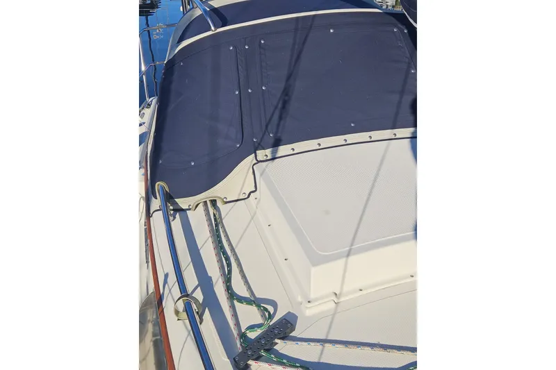Slide: The Image of 2003 Pacific Seacraft Dana 24 sailboat deck with blue canvas cover. - 9