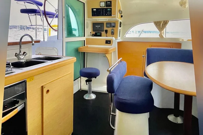 Slide: The Image of Interior of 2008 Lagoon 380 S2 catamaran with kitchen and seating area. - 13