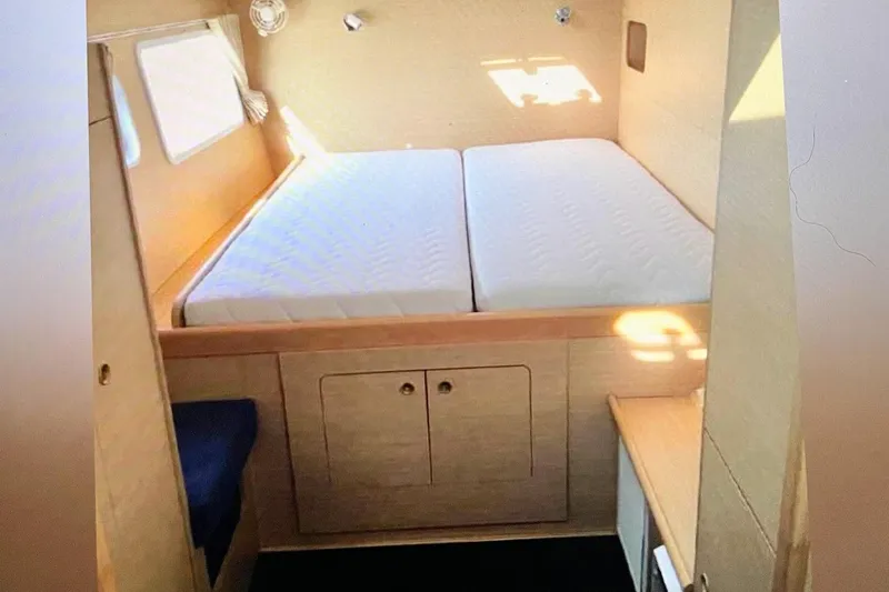 Slide: The Image of Interior cabin of 2008 Lagoon 380 S2 catamaran with double bed and storage. - 14