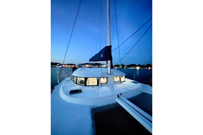 Slide: The Image of 2008 Lagoon 380 S2 catamaran at dusk, anchored on calm waters. - 19