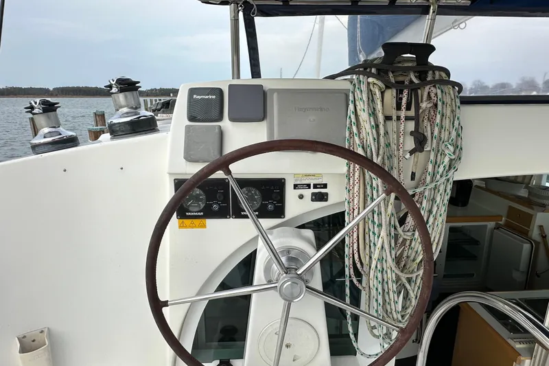 Slide: The Image of Steering wheel and controls of 2008 Lagoon 380 S2 catamaran, with ropes and equipment. - 23