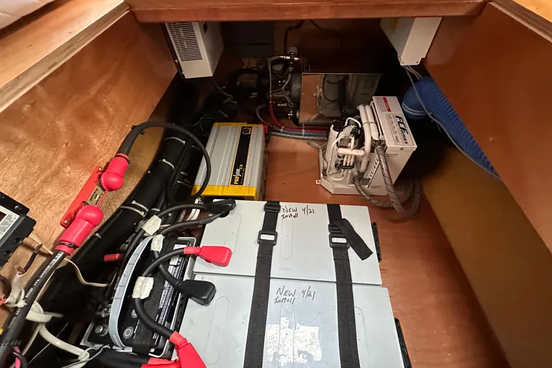 Slide: The Image of Electrical system inside 2008 Lagoon 380 S2 yacht, featuring batteries and wiring components. - 25