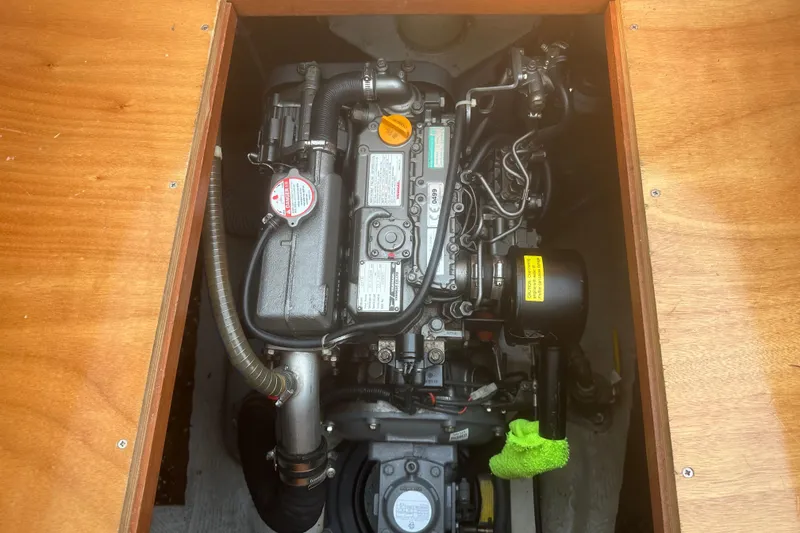 Slide: The Image of Engine compartment of a 2008 Lagoon 380 S2 catamaran, showcasing detailed mechanical components. - 27