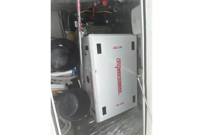 Slide: The Image of Storage compartment of 2008 Lagoon 380 S2 with Westerbeke generator and equipment. - 31