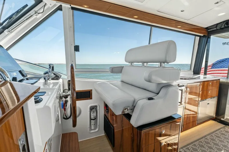 Slide: The Image of Interior of 2026 MJM 47R yacht with luxurious helm seat and ocean view. - 19