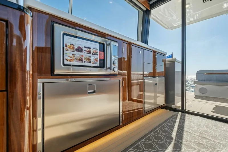 Slide: The Image of Luxurious interior of 2026 MJM 47R yacht with modern kitchen appliances and ocean view. - 22