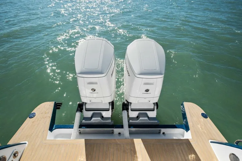 Slide: The Image of 2026 MJM 47R boat with dual outboard engines on sparkling water. - 29