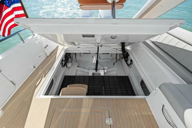 Slide: The Image of Open engine compartment of 2026 MJM 47R yacht with American flag in background. - 31