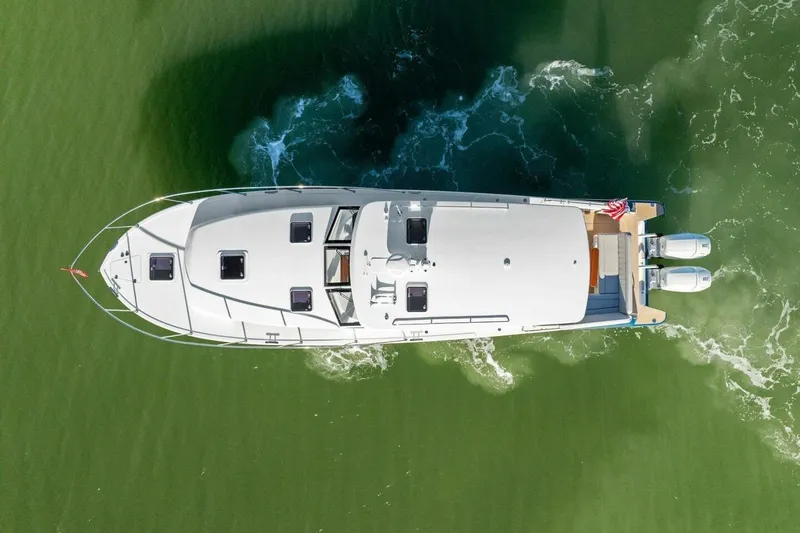 Slide: The Image of Aerial view of 2026 MJM 47R yacht cruising on green water. - 38