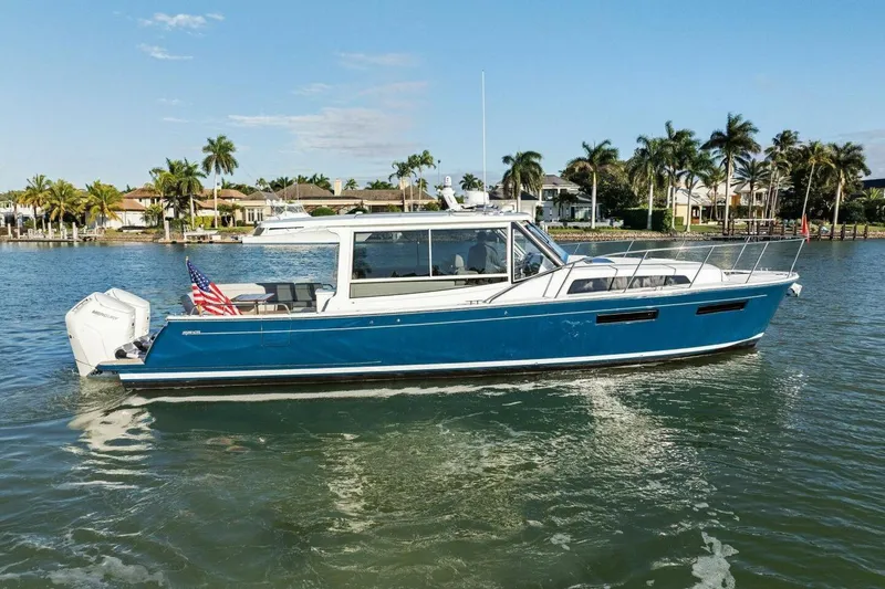 Slide: The Image of 2026 MJM 47R yacht cruising on a sunny day with palm trees in the background. - 40