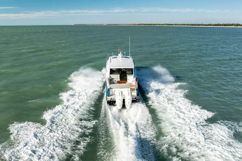 Slide: The Image of 2026 MJM 47R yacht cruising on open water, leaving a wake behind. - 48