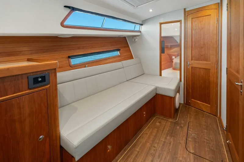 Slide: The Image of Luxurious interior of 2026 MJM 47R yacht with wooden finishes and comfortable seating. - 7