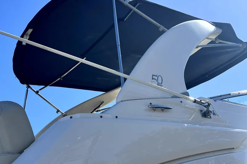 Slide: The Image of 2021 Regal 26 XO boat with canopy under clear blue sky. - 12