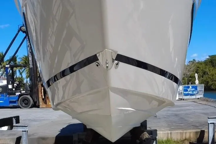 Slide: The Image of 2021 Regal 26 XO boat on trailer, front view, outdoors. - 18