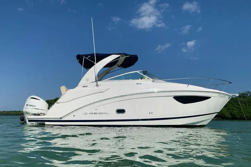 Slide: The Image of 2021 Regal 26 XO boat on display at a Yamaha service center. - 2