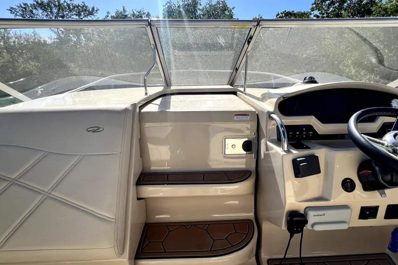 Slide: The Image of 2021 Regal 26 XO boat dashboard with steering wheel and control panel. - 29
