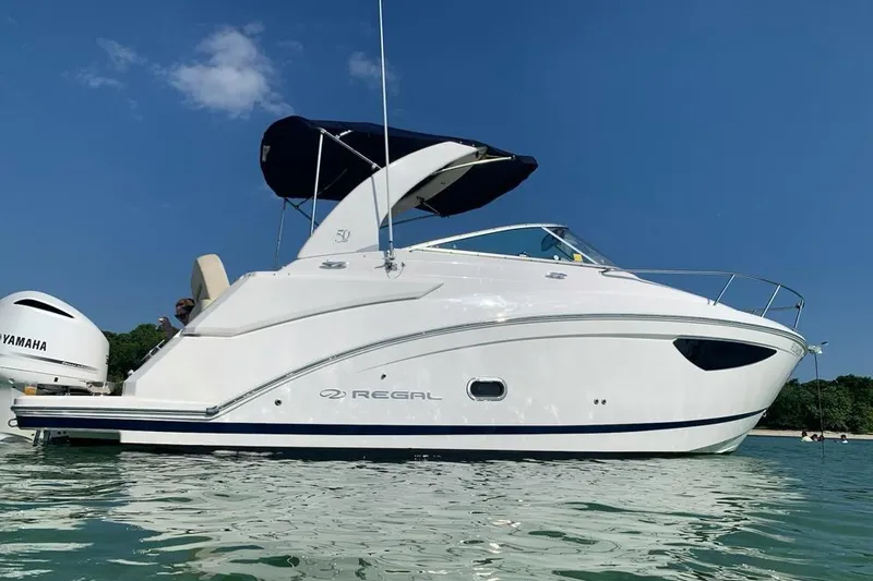 Slide: The Image of 2021 Regal 26 XO boat with Yamaha engine on display stand. - 3