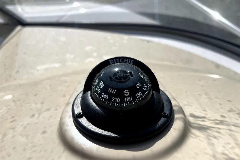 Slide: The Image of Compass on 2021 Regal 26 XO boat dashboard, displaying cardinal directions. - 32