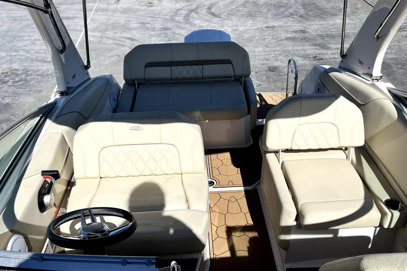Slide: The Image of Interior view of 2021 Regal 26 XO boat with beige seating and steering wheel. - 33