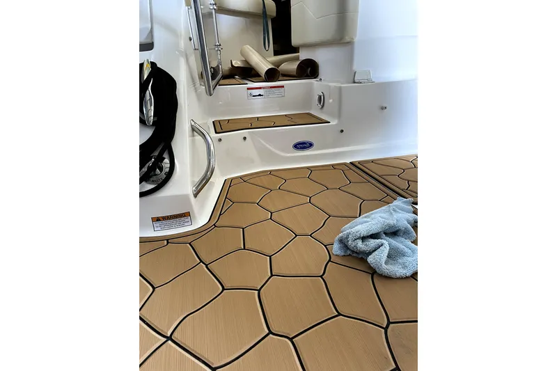 Slide: The Image of 2021 Regal 26 XO boat with 300 horsepower engine, under clear blue sky. - 5