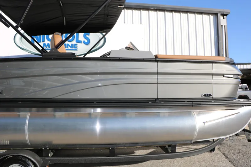 Slide: The Image of 2026 Sylvan L3 LZ DH Platinum Edition Tri-Toon boat, side view, under a canopy. - 13