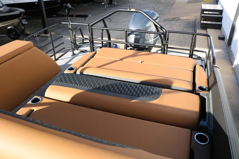 Slide: The Image of 2026 Sylvan L3 LZ DH Platinum Edition Tri-Toon with tan seating and cup holders. - 35