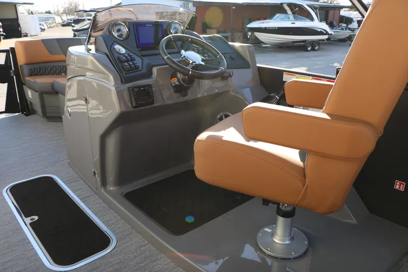 Slide: The Image of 2026 Sylvan L3 LZ DH Platinum Edition Tri-Toon boat interior with captain's chair and control panel. - 37