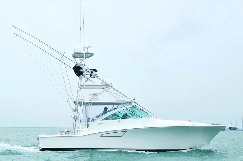The Image of 2004 Cabo 40 Hardtop Express yacht cruising on open water. - 0