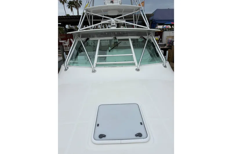 Slide: The Image of 2004 Cabo 40 Hardtop Express boat with sleek design and sturdy windshield. - 10