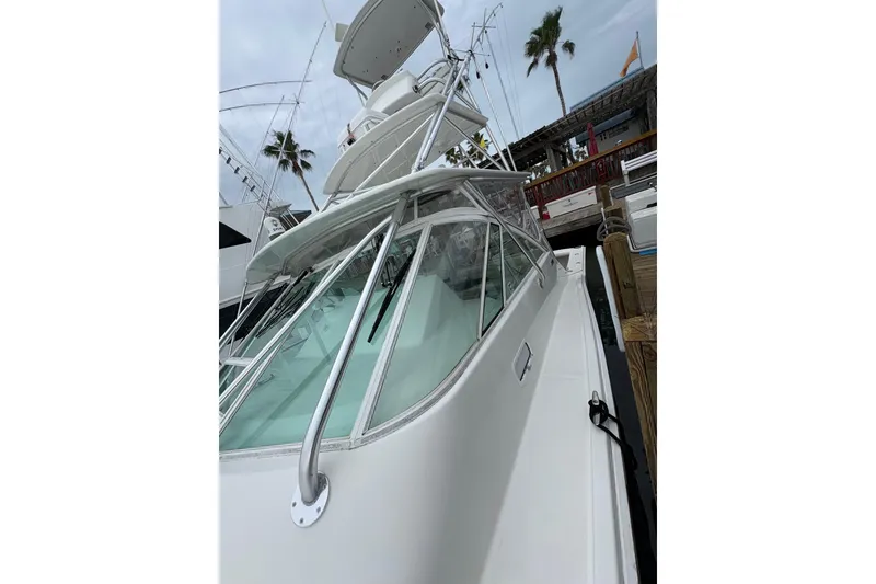 Slide: The Image of 2004 Cabo 40 Hardtop Express yacht docked, showcasing sleek design and modern features. - 12