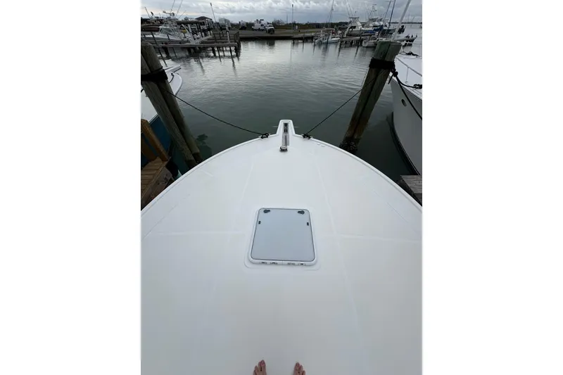 Slide: The Image of Bow view of 2004 Cabo 40 Hardtop Express docked at marina. - 13