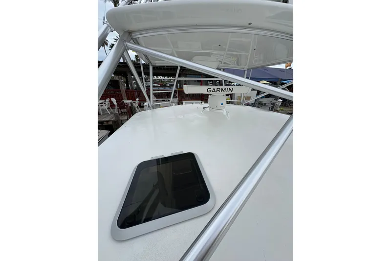 Slide: The Image of 2004 Cabo 40 Hardtop Express boat with Garmin radar and hatch on deck. - 14