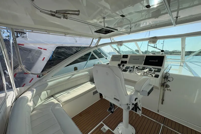 Slide: The Image of 2004 Cabo 40 Hardtop Express helm with modern navigation equipment and luxurious seating. - 20