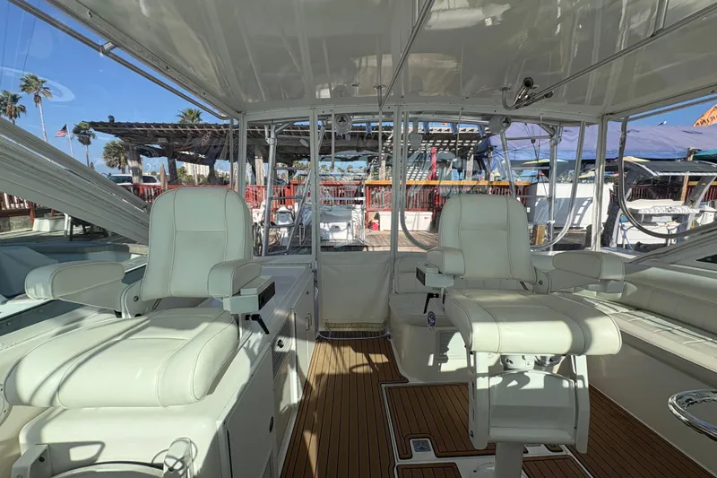 Slide: The Image of Interior of 2004 Cabo 40 Hardtop Express yacht with white seating and wooden flooring. - 21