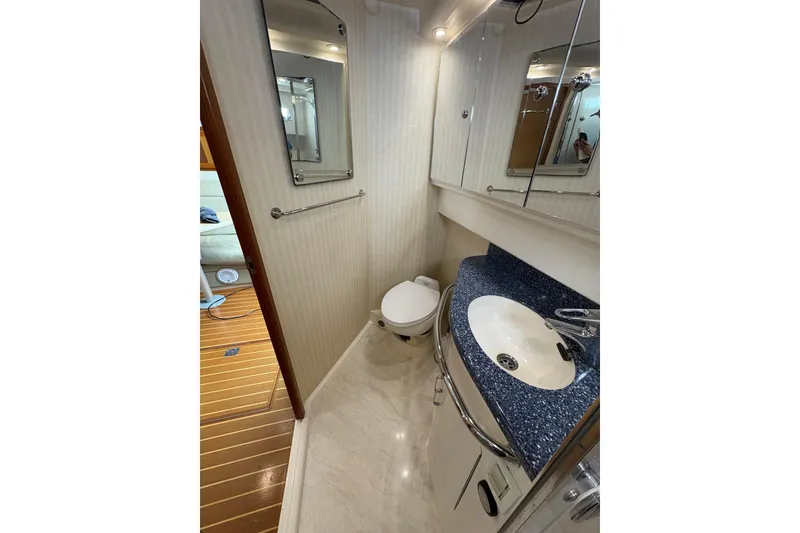 Slide: The Image of Bathroom interior of 2004 Cabo 40 Hardtop Express yacht, featuring sink and toilet. - 26