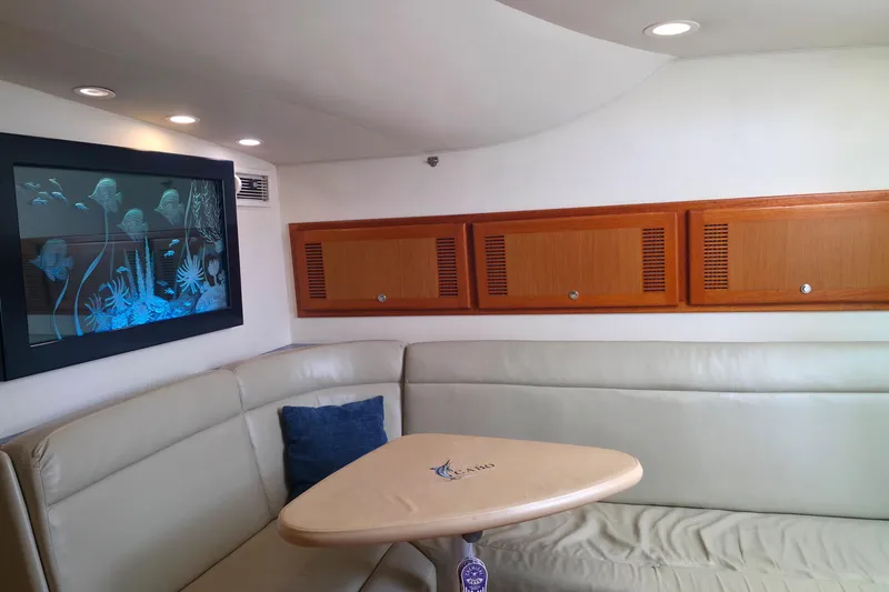 Slide: The Image of Luxurious interior of 2004 Cabo 40 Hardtop Express yacht with elegant seating and marine artwork. - 28