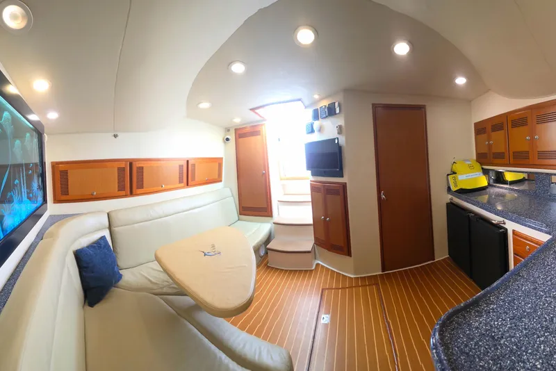 Slide: The Image of Interior of 2004 Cabo 40 Hardtop Express yacht with modern seating and kitchenette. - 29