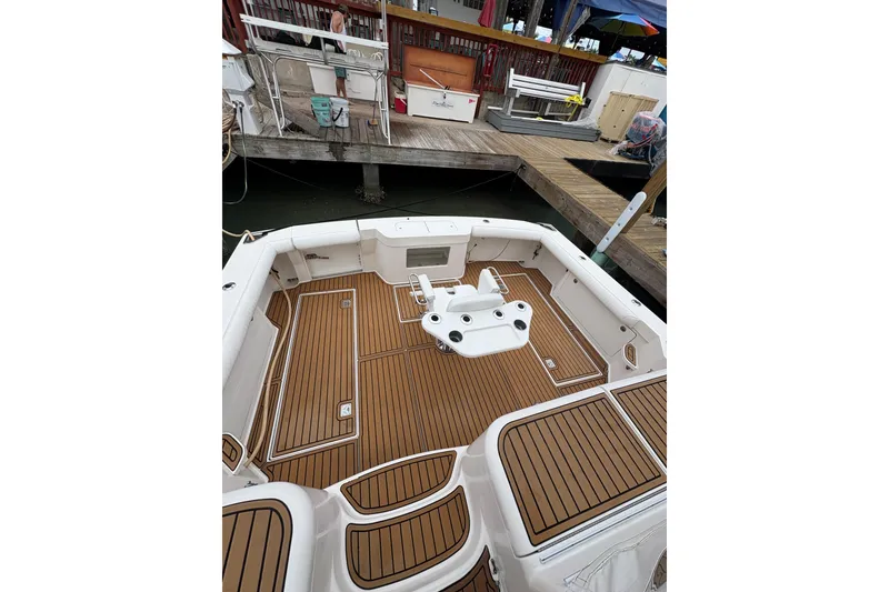 Slide: The Image of 2004 Cabo 40 Hardtop Express boat with teak deck at marina. - 7