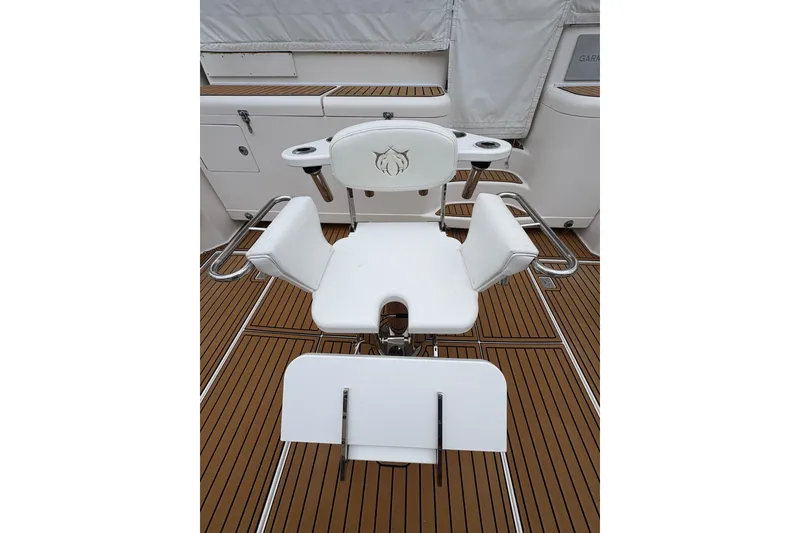 Slide: The Image of White fishing chair on 2004 Cabo 40 Hardtop Express boat deck. - 8