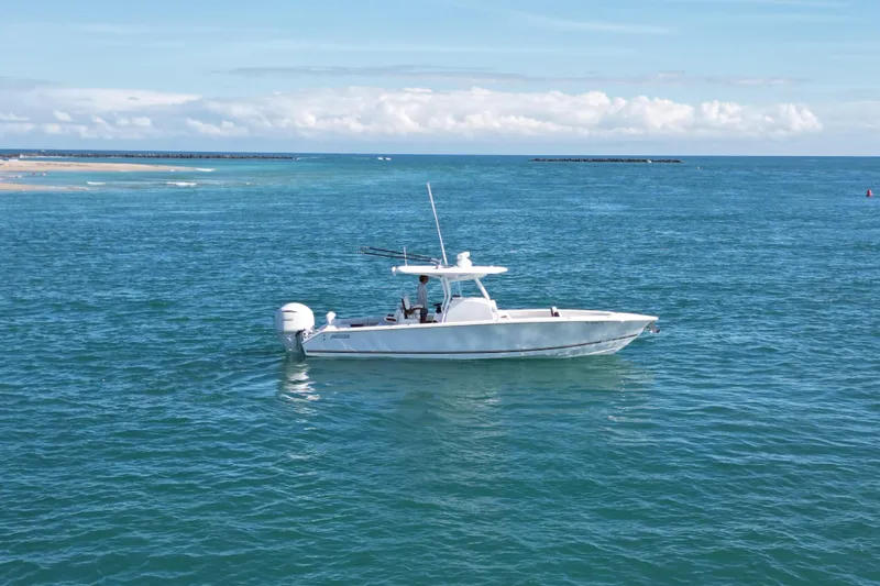 Slide: The Image of 2025 Jupiter 32 FS boat cruising on open blue ocean under clear sky. - 17