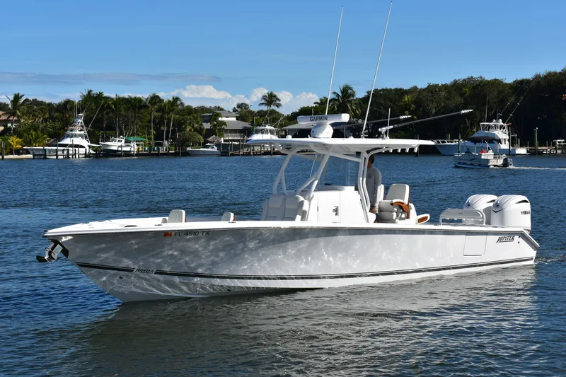 Slide: The Image of 2025 Jupiter 32 FS boat cruising on a sunny day in a scenic marina. - 18