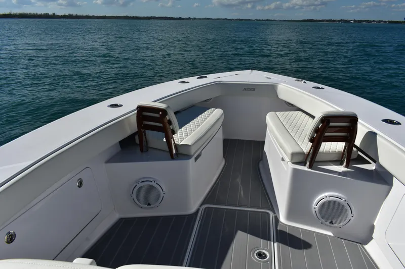Slide: The Image of 2025 Jupiter 32 FS boat interior with cushioned seating and ocean view. - 4