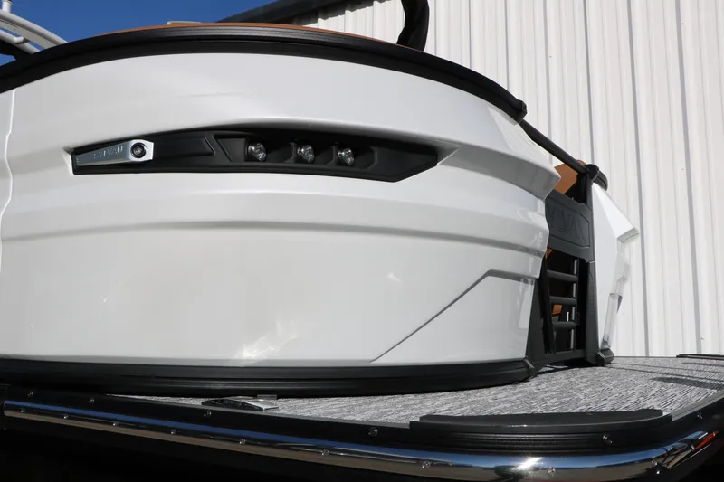 Slide: The Image of 2026 Sylvan G5 LZ DH Platinum Edition Tri-Toon boat, sleek design, docked outdoors. - 12