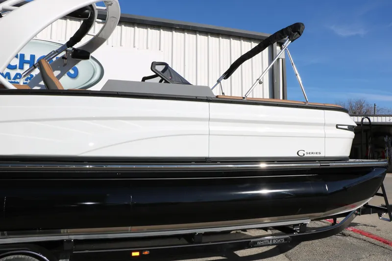 Slide: The Image of 2026 Sylvan G5 LZ DH Platinum Edition Tri-Toon boat, side view, in a marina setting. - 15