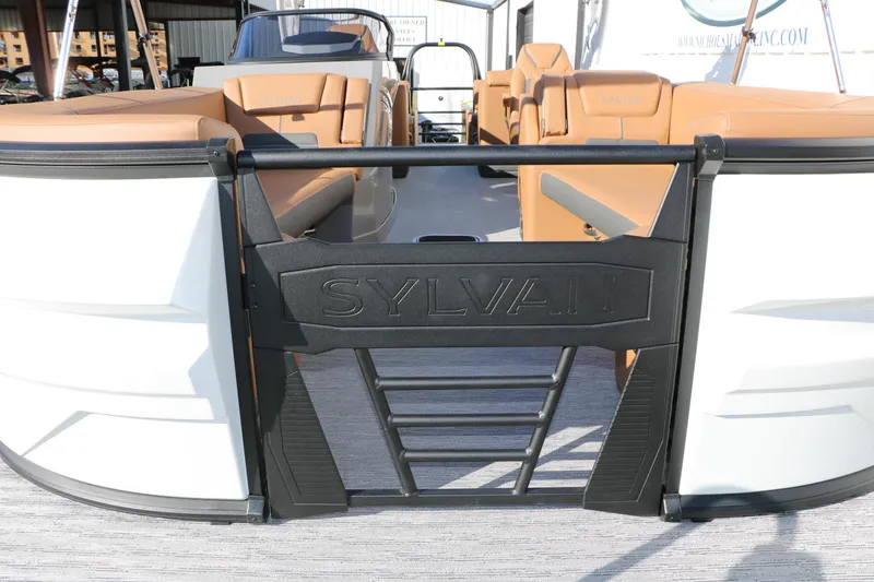 Slide: The Image of 2026 Sylvan G5 LZ DH Platinum Edition Tri-Toon boat with tan seating and sleek design. - 21