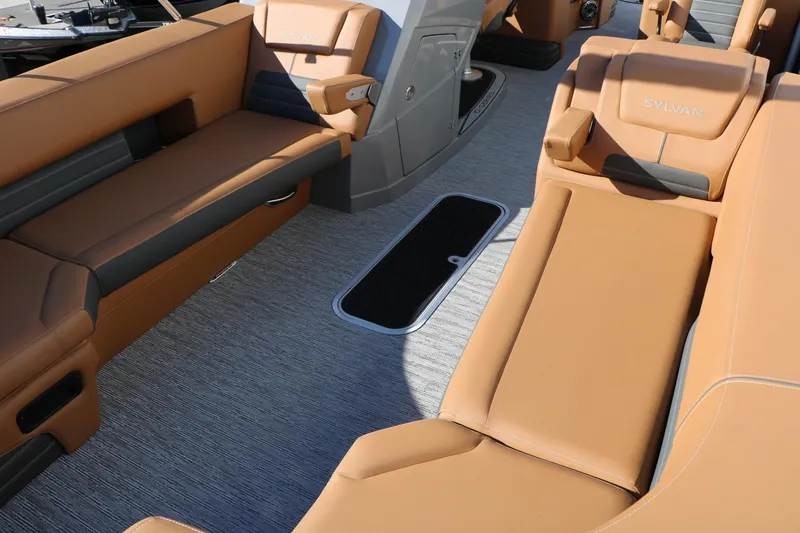 Slide: The Image of Luxurious interior of 2026 Sylvan G5 LZ DH Platinum Edition Tri-Toon with tan seating. - 24