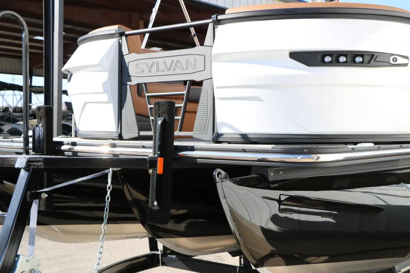 Slide: The Image of 2026 Sylvan G5 LZ DH Platinum Edition Tri-Toon boat, sleek design, docked on trailer. - 4