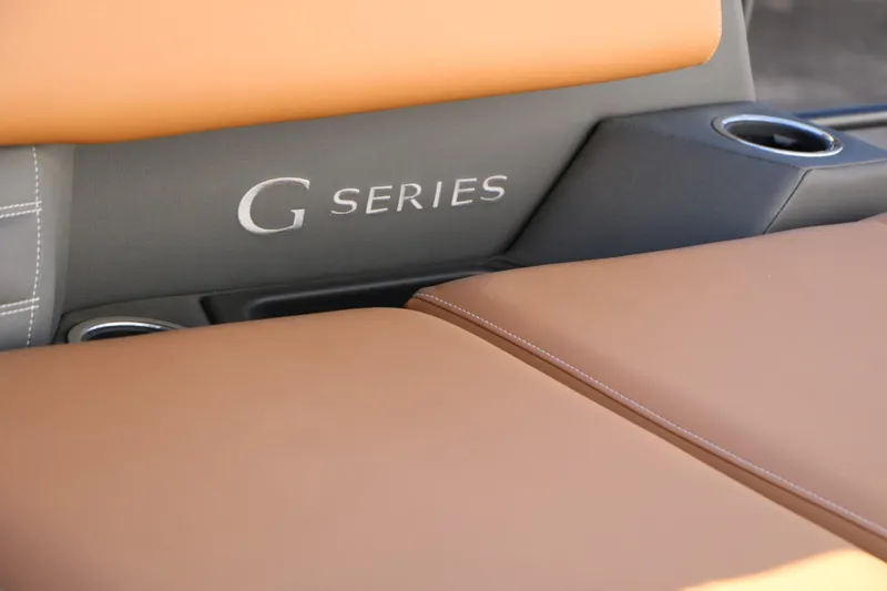 Slide: The Image of Close-up of Sylvan G Series boat seating, featuring tan leather and cup holders. - 40