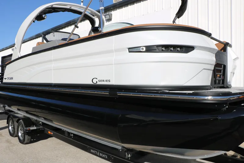 Slide: The Image of 2026 Sylvan G5 LZ DH Platinum Edition Tri-Toon boat, sleek design, on trailer. - 5
