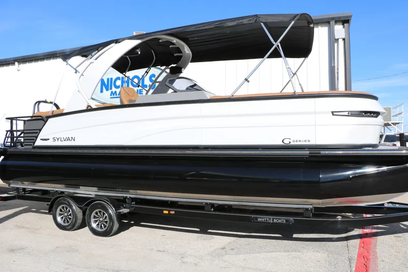 Slide: The Image of 2026 Sylvan G5 LZ DH Platinum Edition Tri-Toon boat on trailer, outdoor display. - 55